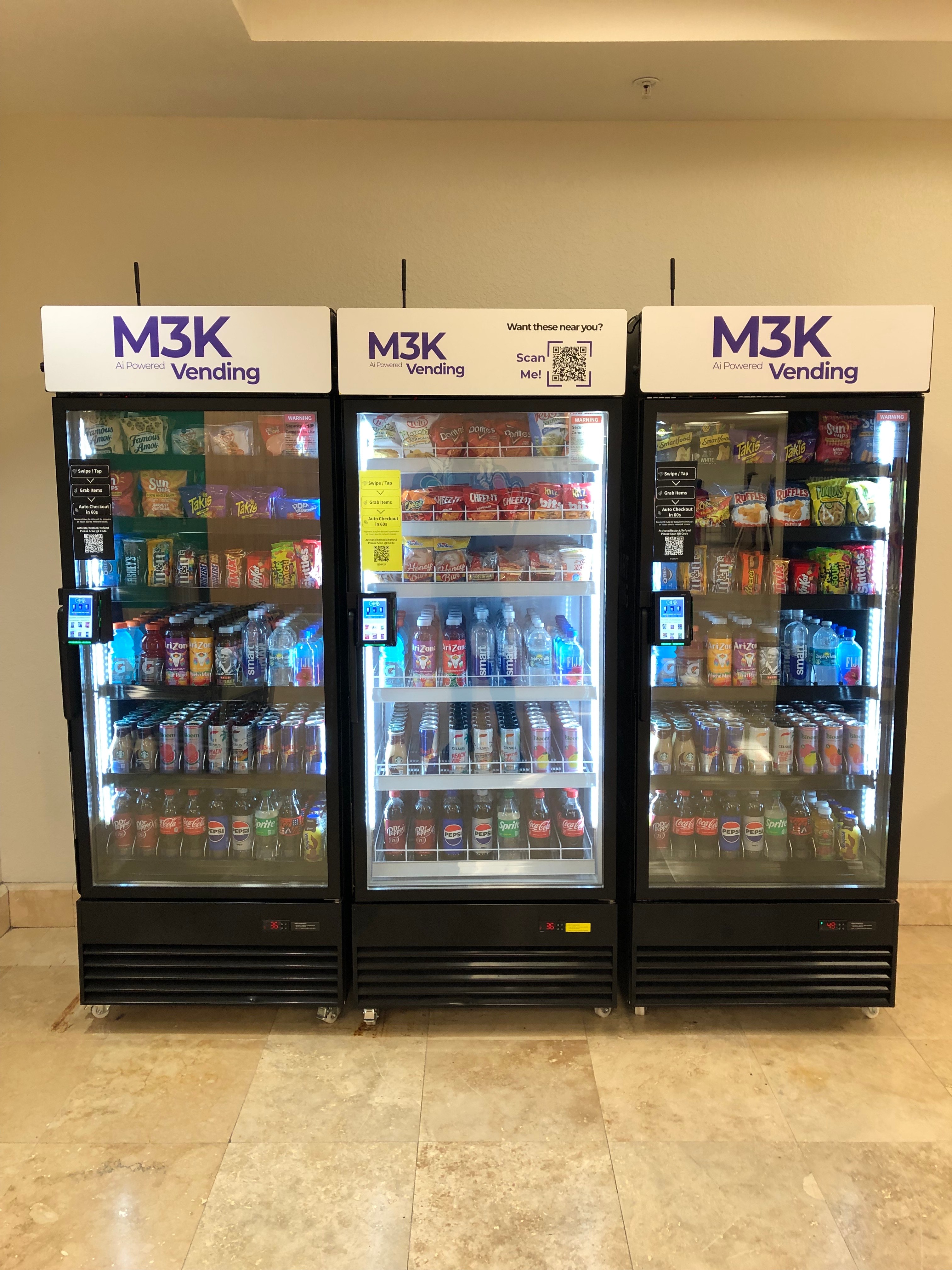 Three M3K AI-powered vending machines side by side, showing the modern glass-front design with M3K branding